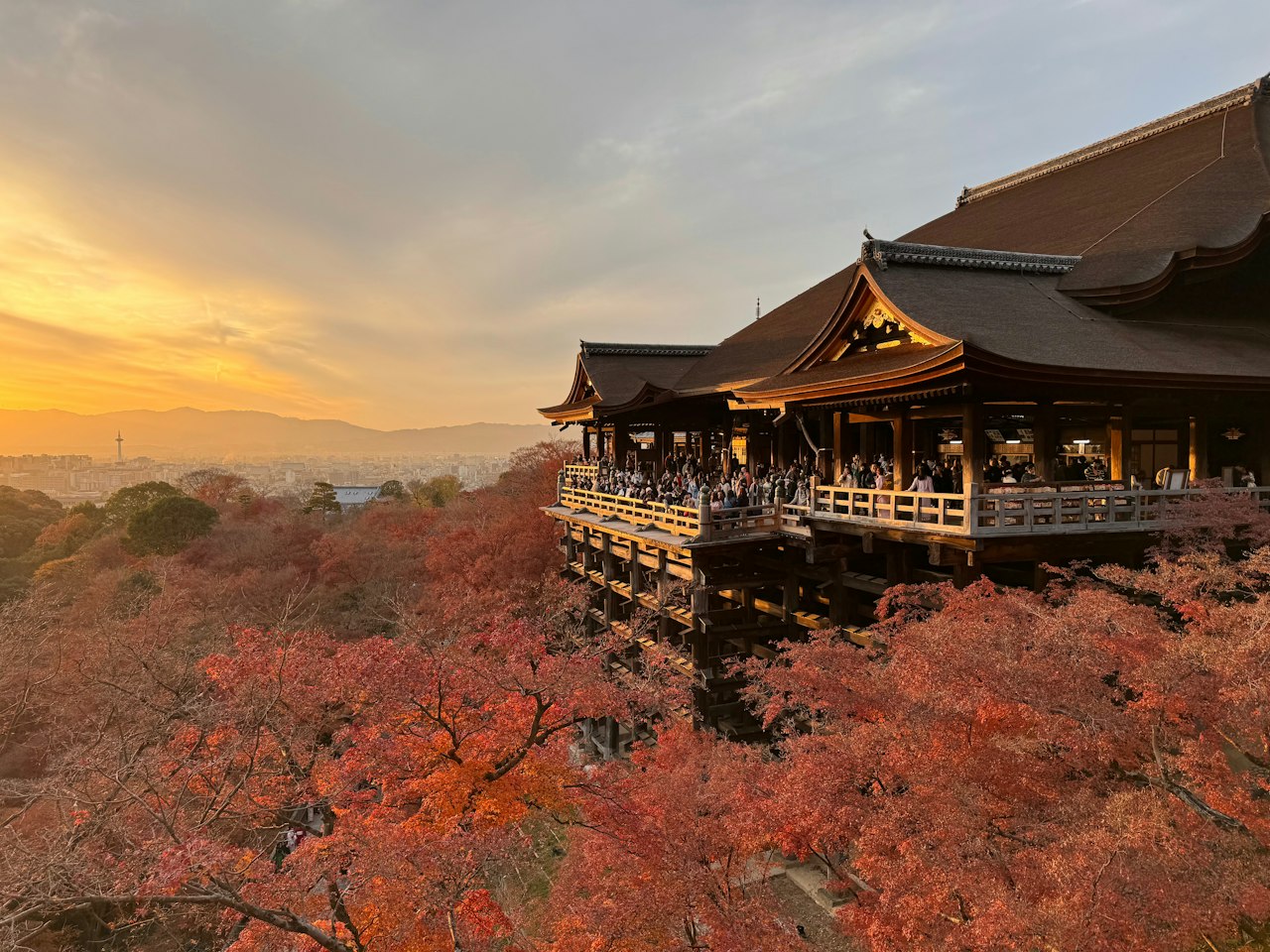 a pagoda on top of a hill with trees in the foreground