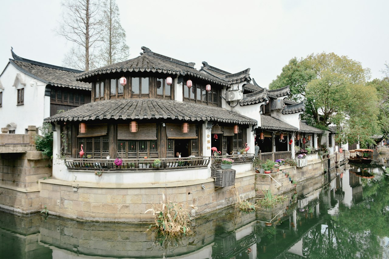Traditional chinese architecture sits along a waterway
