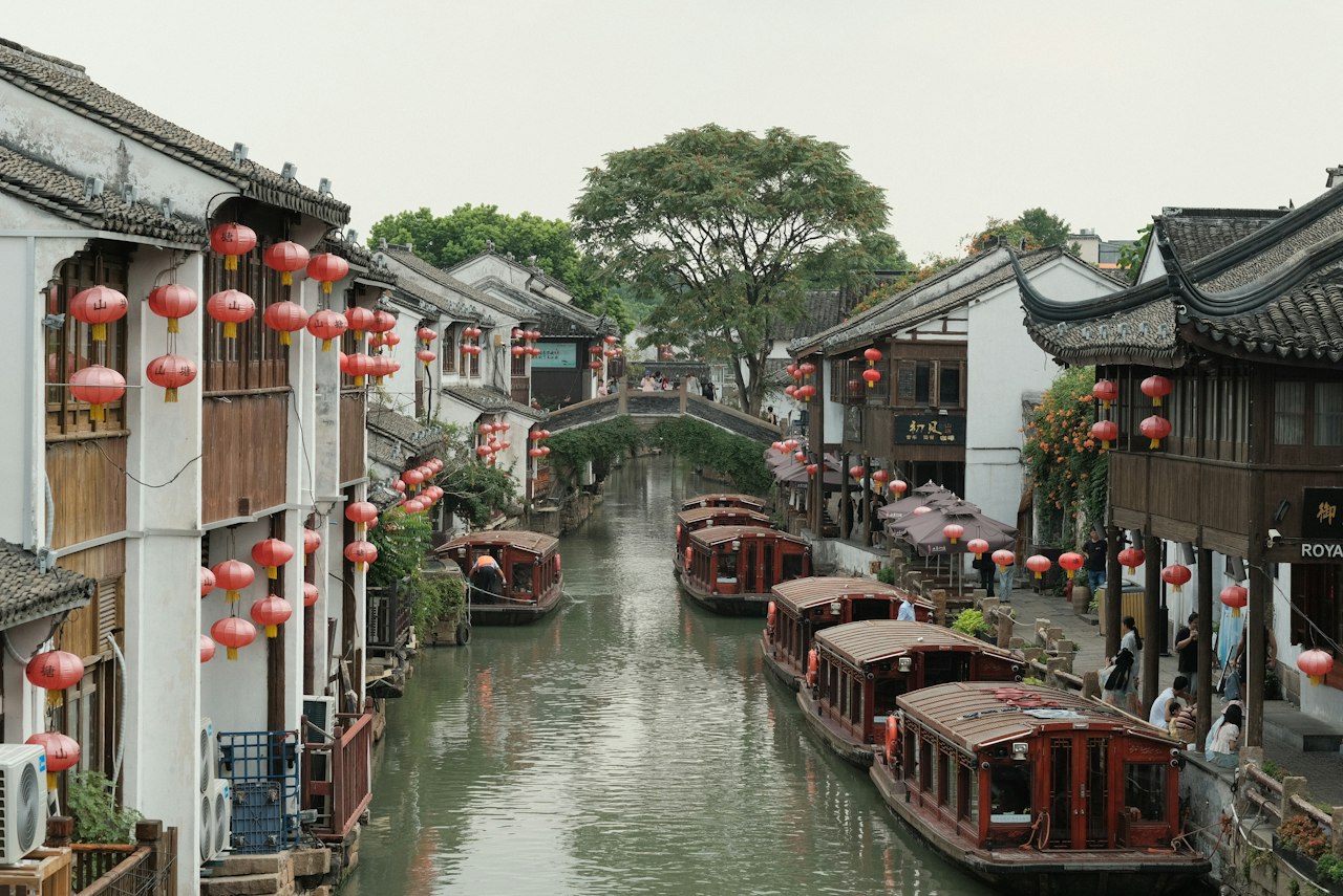 A canal filled with lots of boats next to buildings