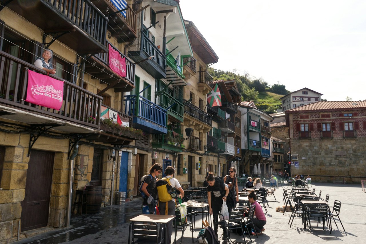 People gathered in a town square with buildings
