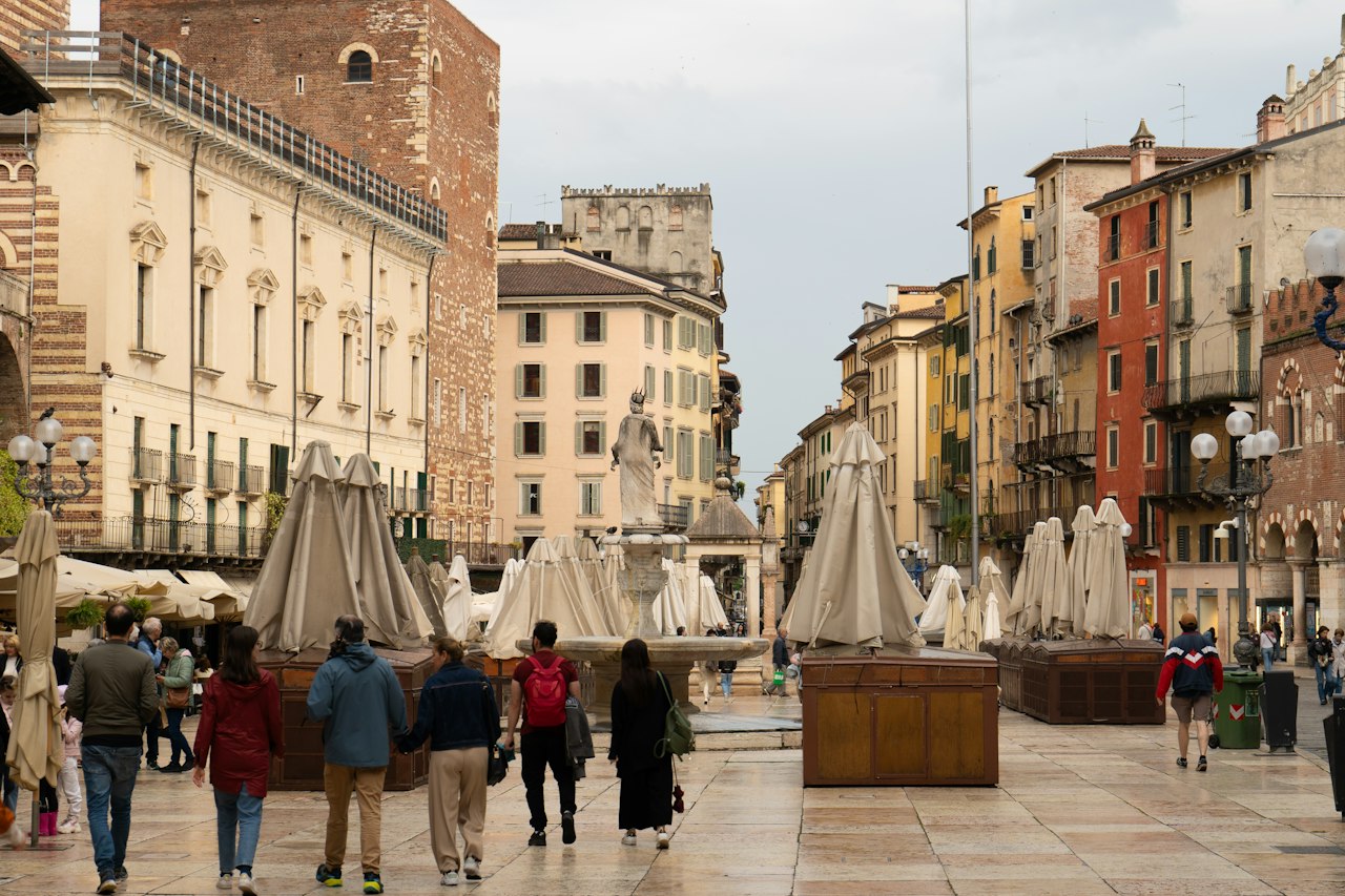 People walk in an italian city square