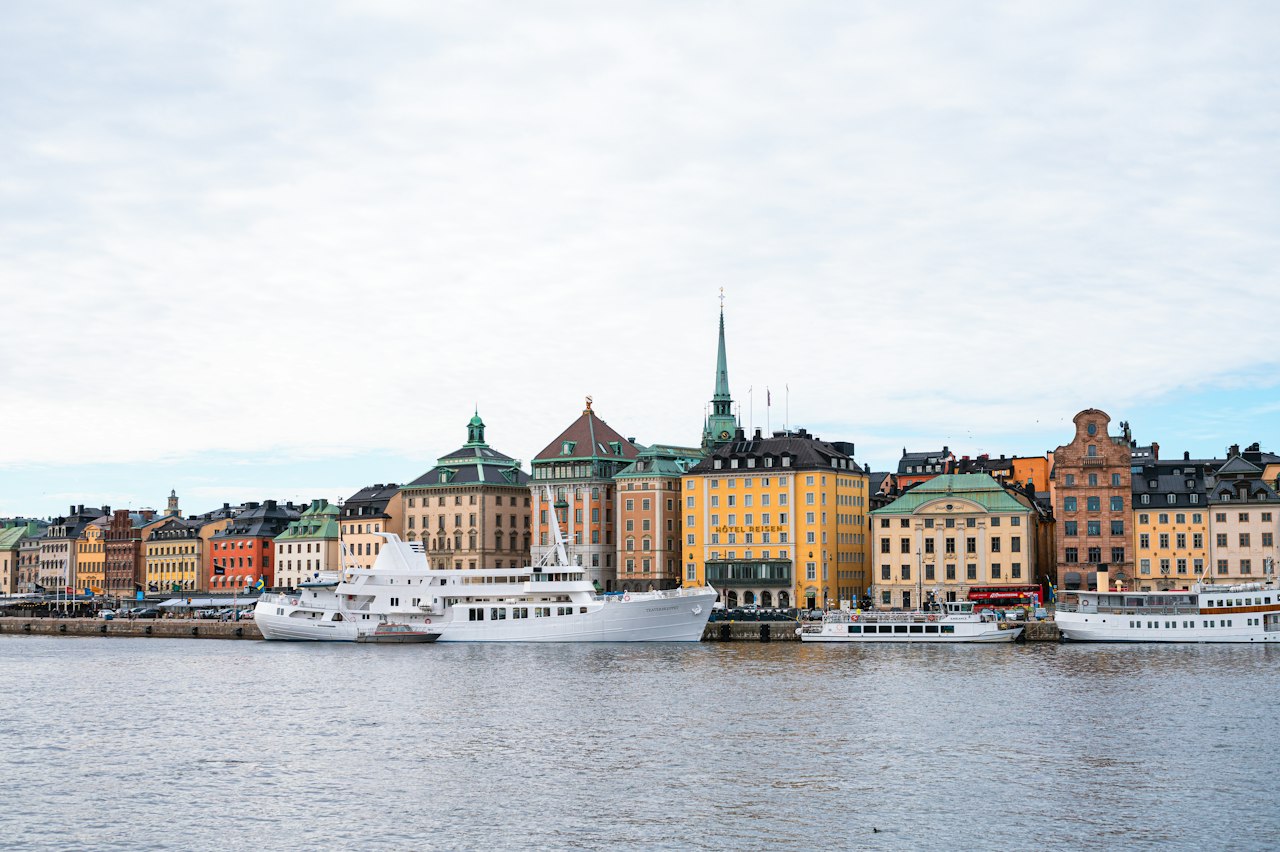 Colorful buildings line the waterfront with boats in the water