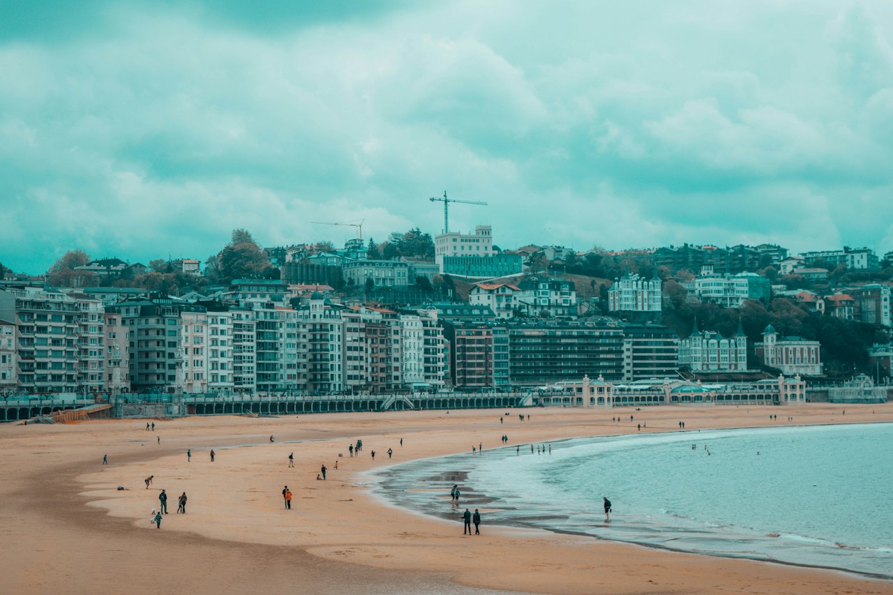 people walking on shore near buildings during daytime