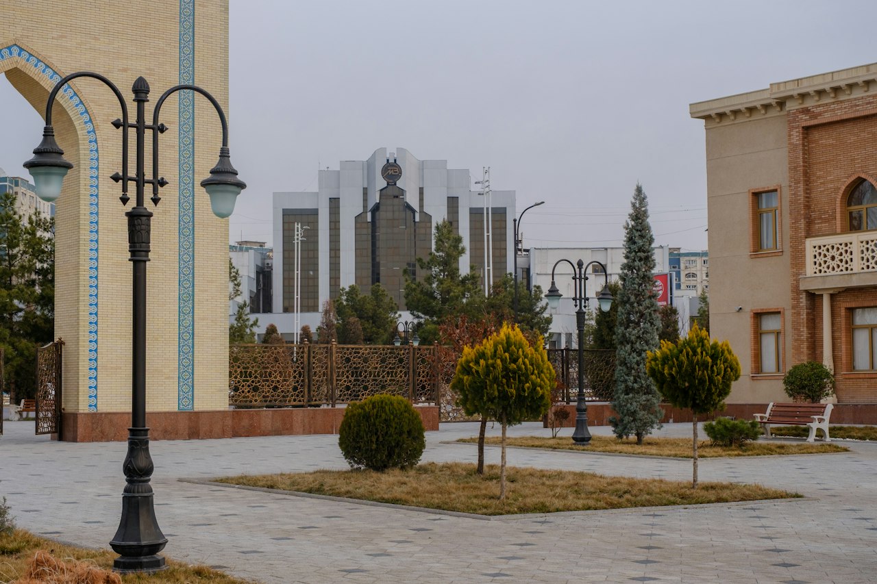 Architectural square with a lamp post, arch, and modern building