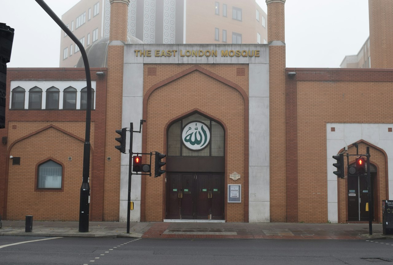 a large brick building with a clock on the front of it